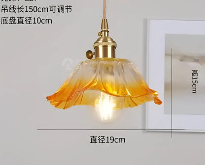 A warm-toned amber glass pendant light with brass fixture and petal design for decorbites blue glass pendant lights collection