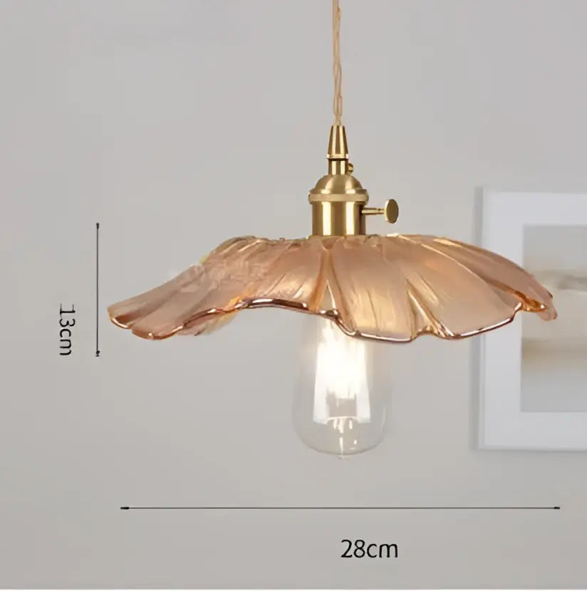 A delicate golden-toned glass pendant light with petal-shaped shade and exposed bulb complements decorbites blue glass pendant lights