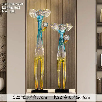 Translucent blue and yellow resin giraffe floor decoration sculpture with crystal ears and spherical trunk ornament for living room