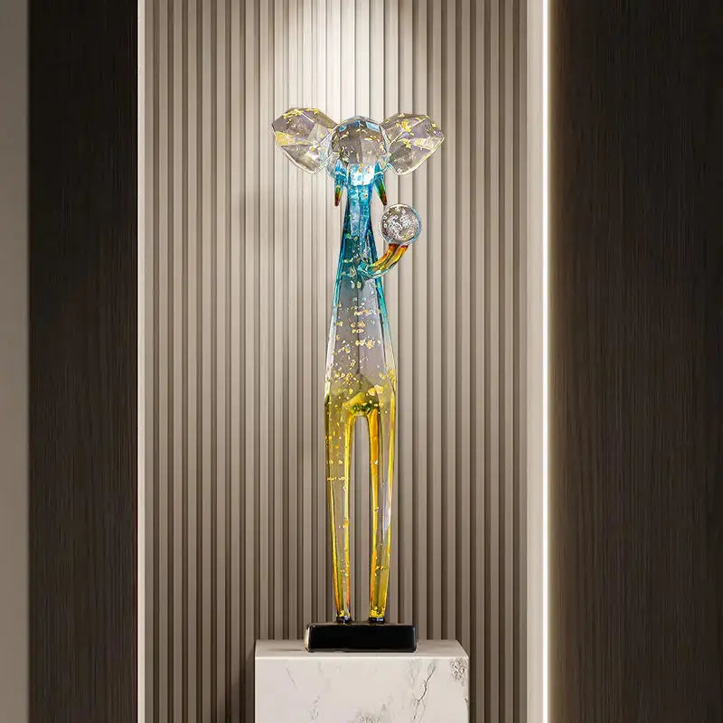 Translucent blue and yellow glass elephant floor decoration sculpture with a stylized figure and diamond-like ears for living room