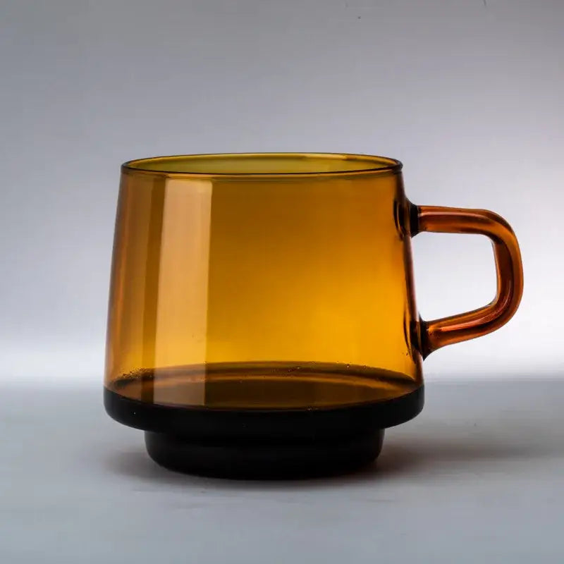 Amber-colored glass coffee mug with black base and handle heat resistant for kitchen use