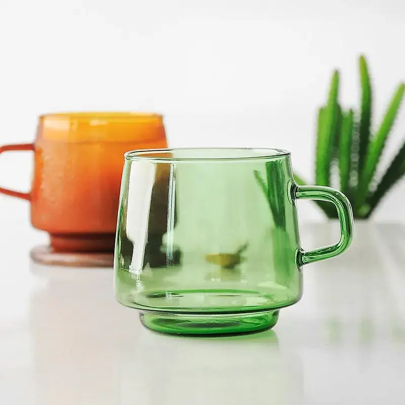 Translucent green glass coffee mug with sturdy handle and flared rim heat resistant for kitchen use