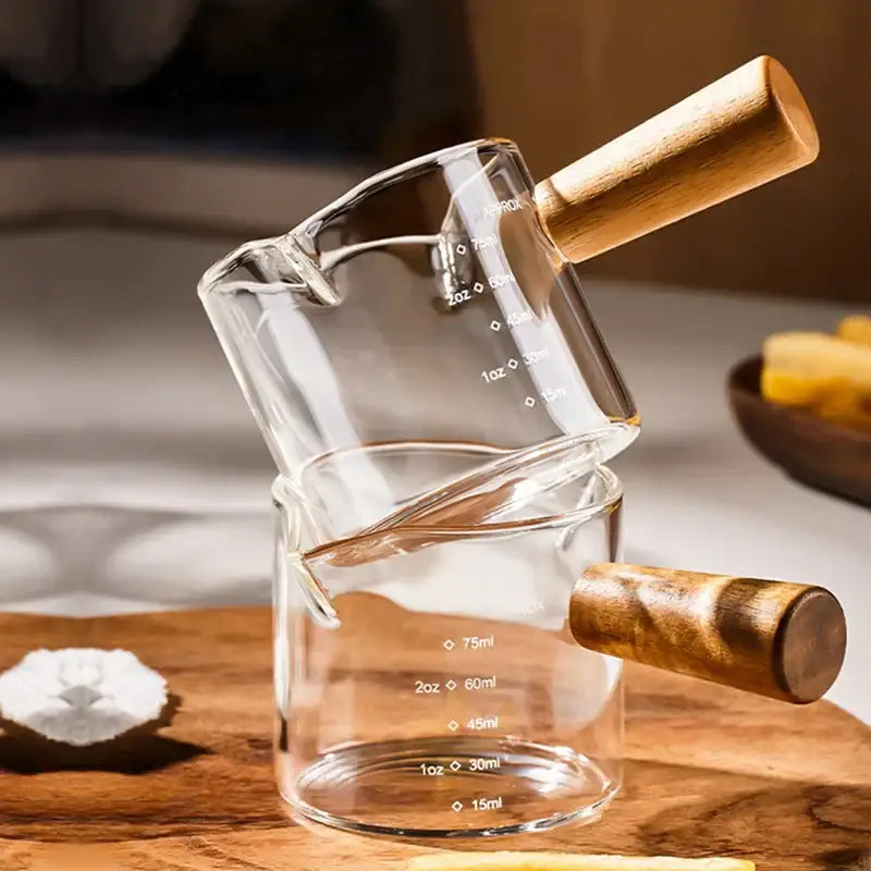 Stacked transparent glass espresso measuring cups with wood handle and clear glass material for kitchen use