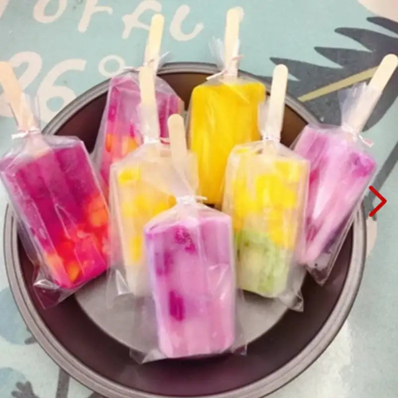 Colorful layered frozen ice cream in transparent pink ice cream bags with gold ribbon for kitchen storage