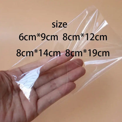 Transparent pink ice cream bags with gold ribbon available in clear plastic sizes 6cm by 9cm to 8cm by 19cm