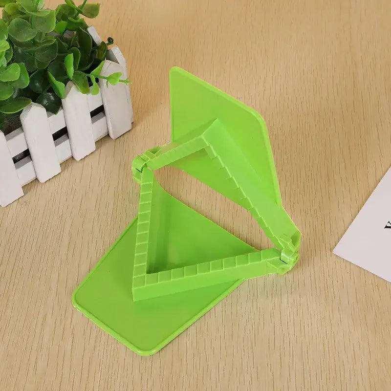 Bright green plastic triangular stand with foldable design in dumpling maker set for easy kitchen use