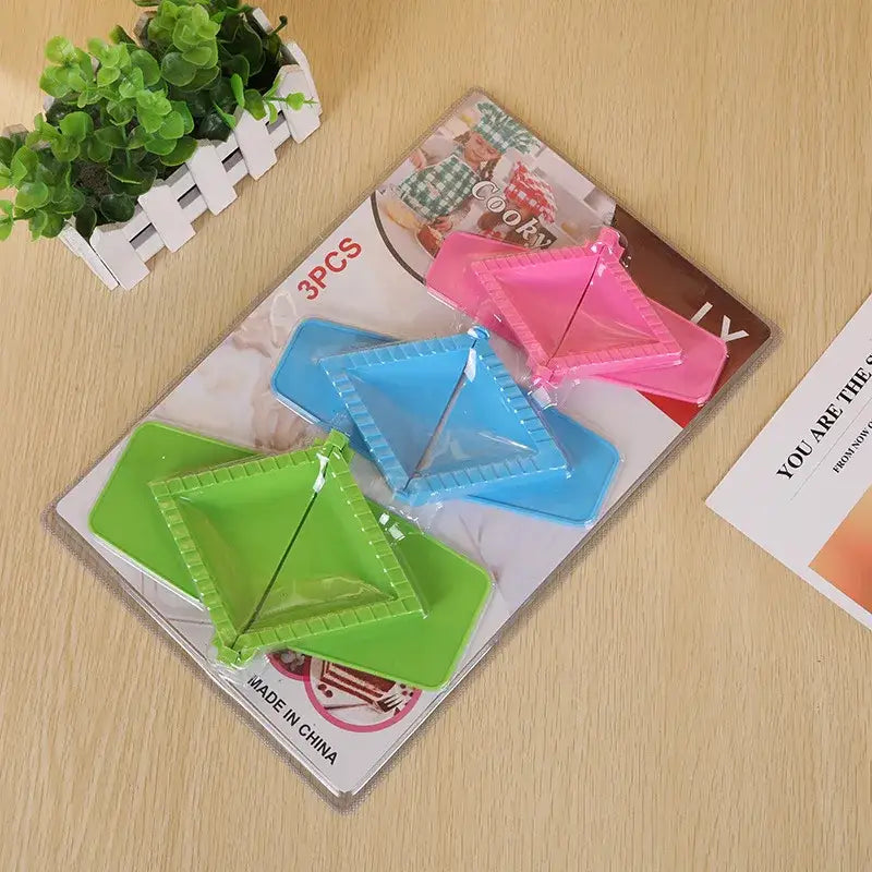 Set of three colorful pink blue and green plastic triangle dumpling maker set for easy kitchen use