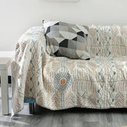 Tribal beige quilted cotton sofa throw blanket featuring geometric and tribal patterns in gray peach and black