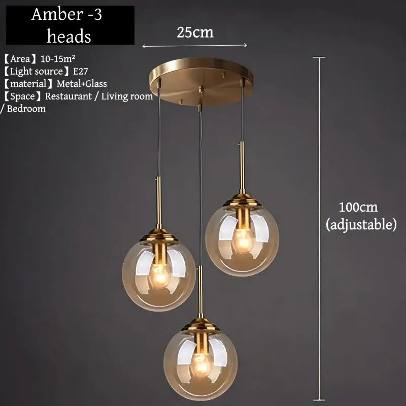 Brass-finished pendant light with three amber glass globes and polished steel accents for dining room use