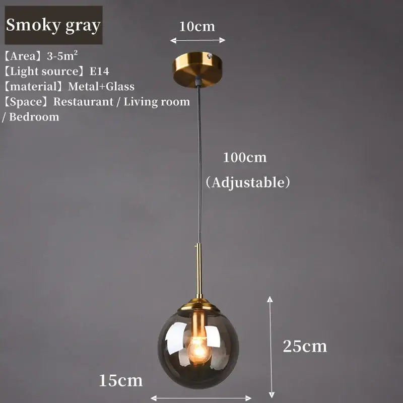 A sleek smoky gray glass pendant light with polished steel brass fixture and adjustable chain for dining room lighting