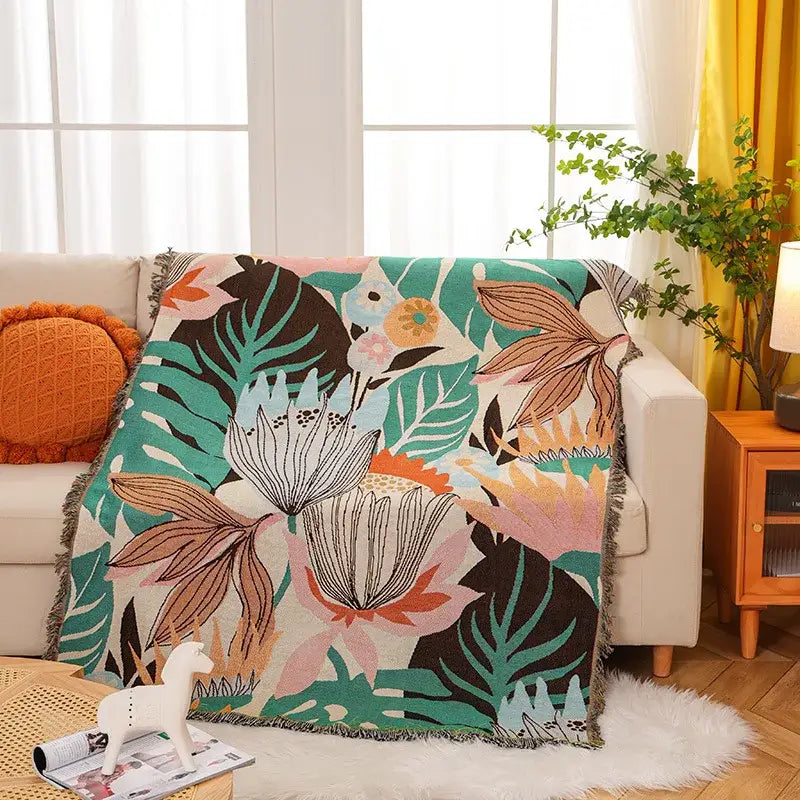 Cozy knit throw blanket with vibrant tropical floral pattern in teal pink and cream for decorbites cozy knit decor