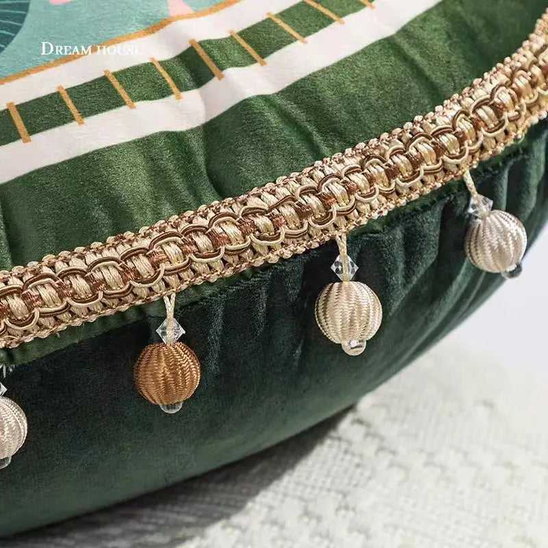 Gold-toned braided trim with crystal accents adorns the edge of a tropical green ethnic print tassel cushion cover decorbites