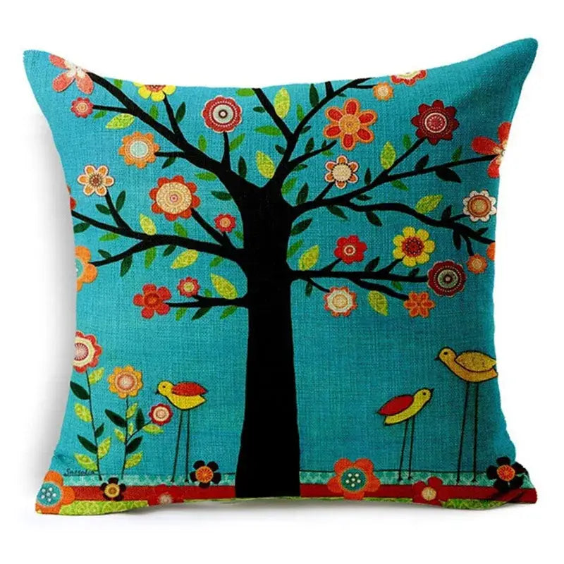 Turquoise throw pillow with black tree, colorful flowers, yellow birds, and green leaves decorative design for home decor