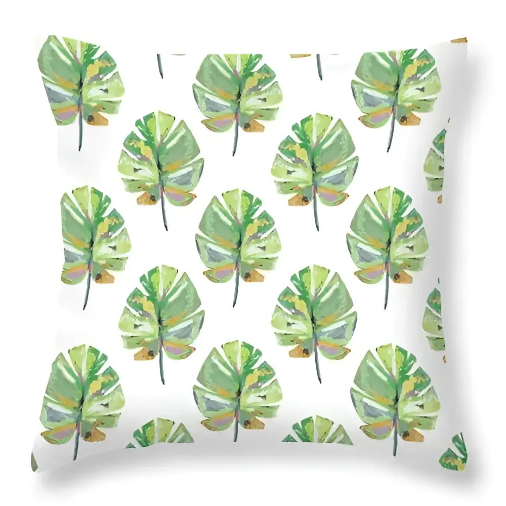 White throw pillow with repeating watercolor pattern of green leaves decorative for tropical home decor