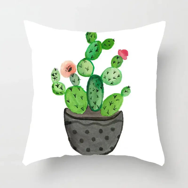 White throw pillow with watercolor green leaves and pink flowers in gray polka-dotted pot for home decor