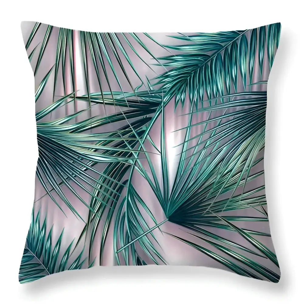 A square throw pillow with vibrant teal green leaves decorative design on a soft pink background for home decor