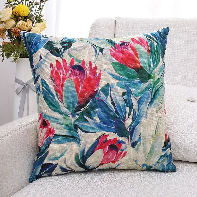 Vibrant cushion cover with bold pink protea and green plant leaves on beige linen for decorbites green plant decor