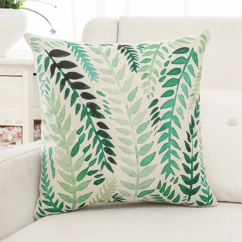 Square cushion cover with green plant leaves pattern in varying shades on light beige linen fabric for living room decorbites
