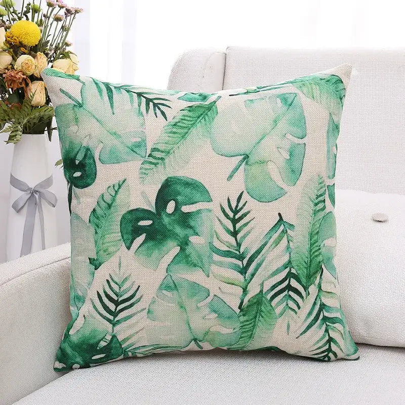 Tropical green plant leaves cushion cover made of textured linen fabric with watercolor style pattern on beige background