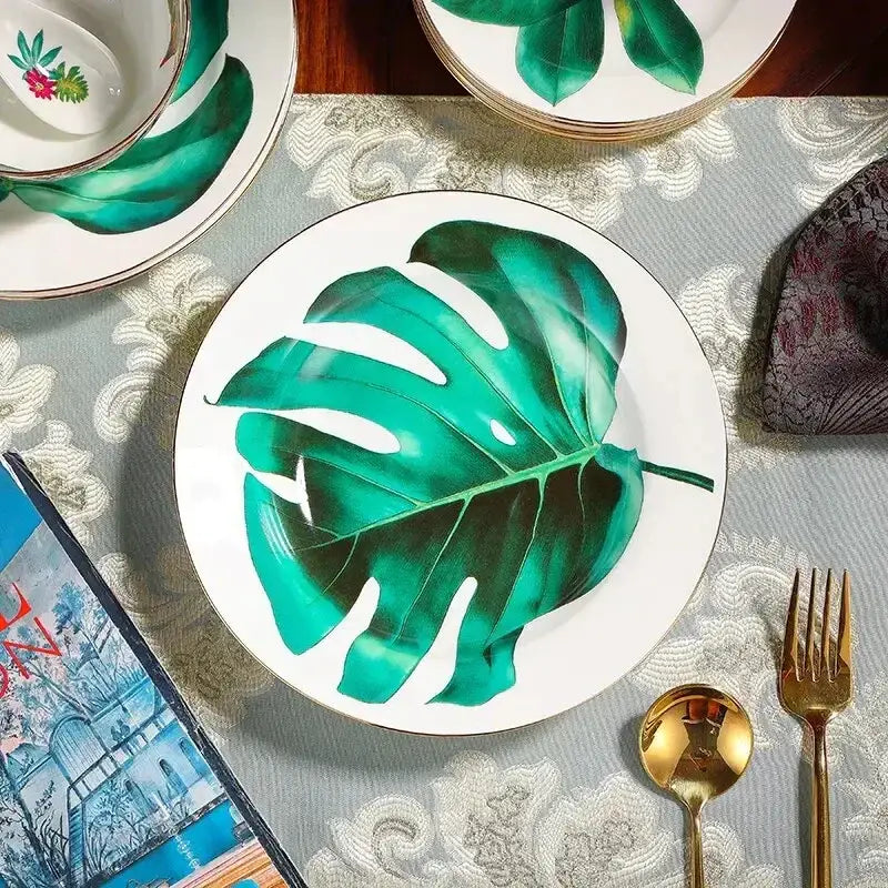 White ceramic plate with vibrant green leaf and gold trim from tropical green leaf collection porcelain tea set