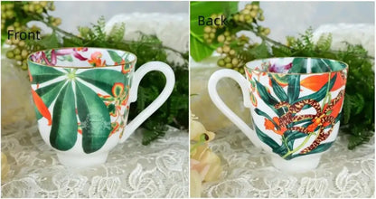 A white ceramic mug from the tropical green leaf collection with vibrant leaves and flowers for an elegant dining experience