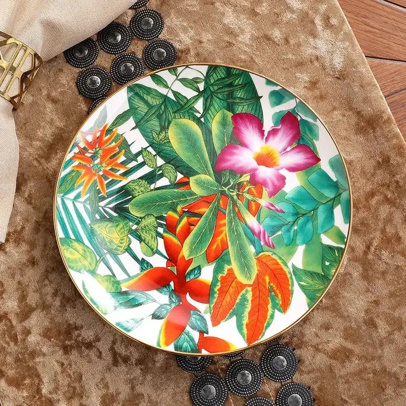 A vibrant tropical-themed porcelain plate with gold rim and bold flowers from the green leaf collection for dining experience