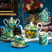 A vibrant green leaf collection porcelain tea set with yellow tropical leaf patterns and gold trim for dining experience