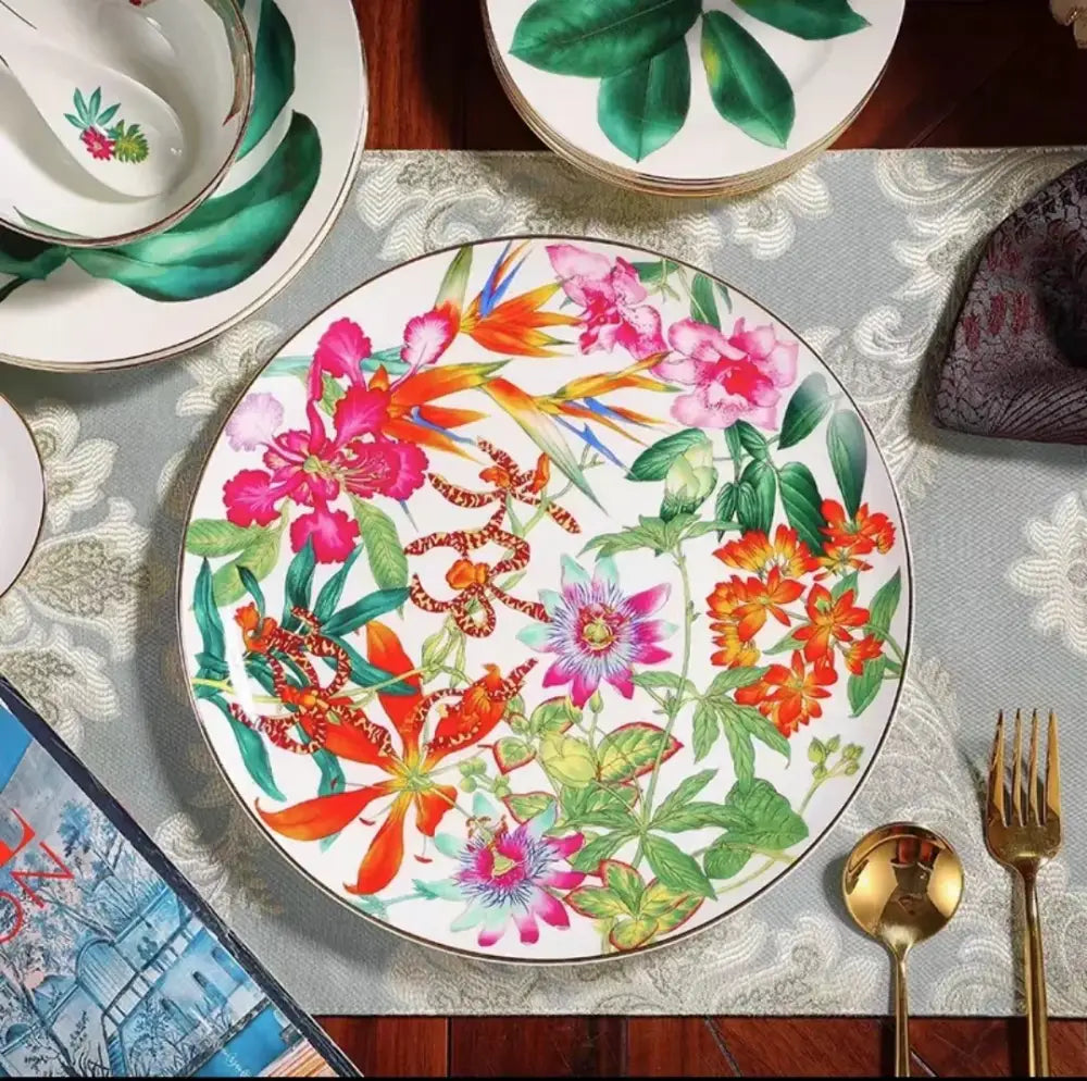A vibrant white ceramic dinner plate with colorful tropical floral pattern from the green leaf collection porcelain tea set