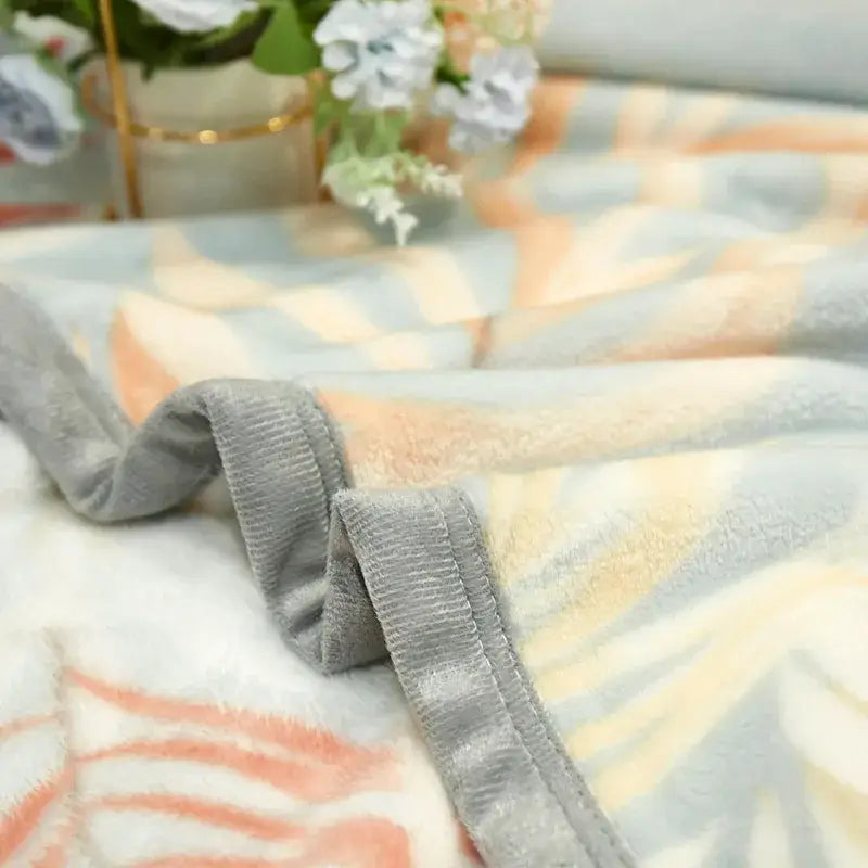 Tropical leaf light blue cozy flannel blanket with peach and pale blue stripes on plush fleece and gray ribbed border decorbites cozy flannel