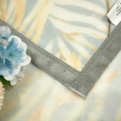 Tropical leaf light blue cozy flannel blanket with light blue cream zebra stripes and silver edges decorbites cozy flannel