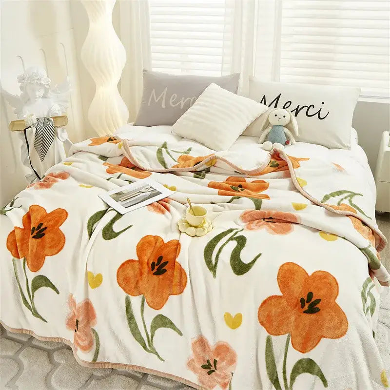 Tropical leaf light blue cozy flannel blanket bedroom throw with a white cozy flannel blanket featuring orange flowers and yellow hearts