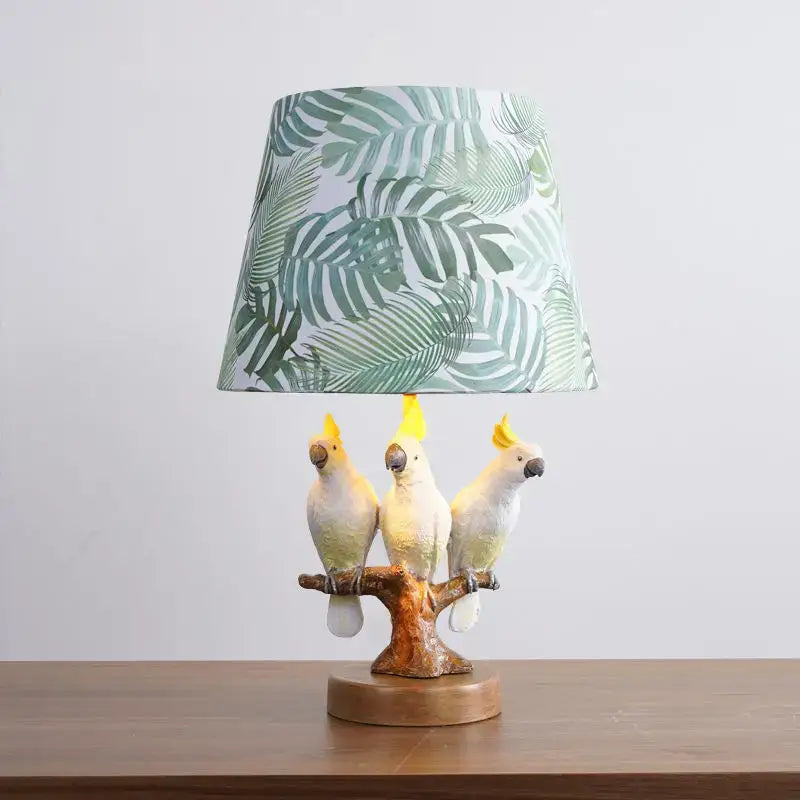 Tropical parrot desk lamp with three white cockatoos on brown branch base and green leaf shade for children room decorbites cartoon parrot desk