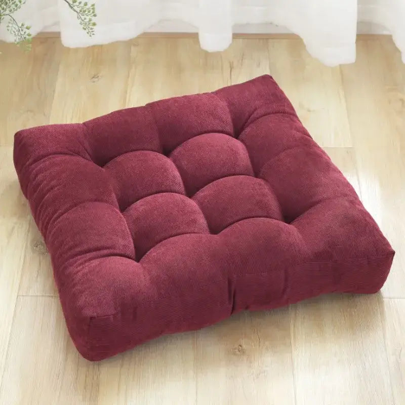 A deep red square corduroy floor seat cushion with button tufting from decorbites corduroy floor collection