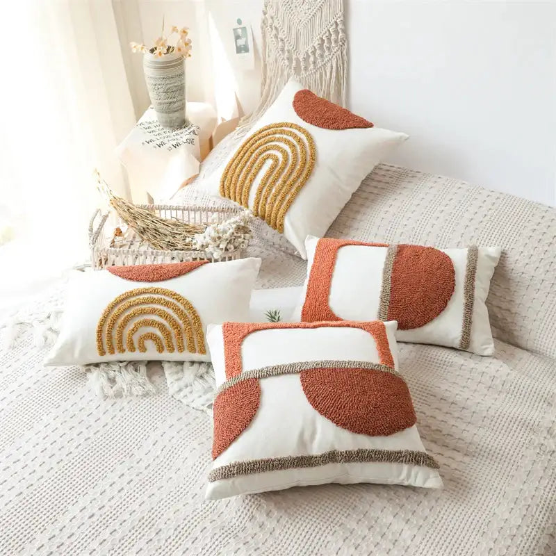 Set of four white cushion covers with burnt orange and mustard yellow decorbites gematric tufted embroidery