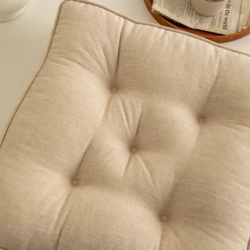 Beige linen tufted button cushion with soft textured surface and subtle button detailing for living room decorbites button cushion