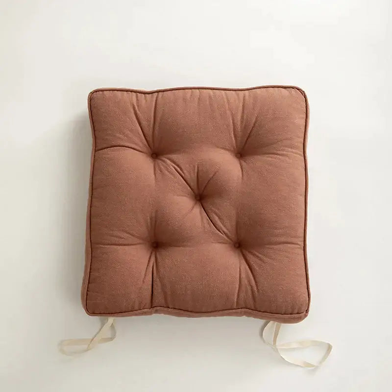 Square tufted button cushion in soft terracotta fabric with matching ties for living room decorbites button cushion