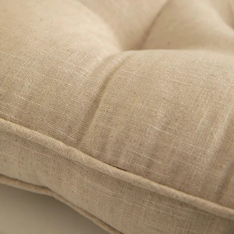 Beige linen decorbites button cushion with soft textured weave and subtle tufted stitching for living room decor