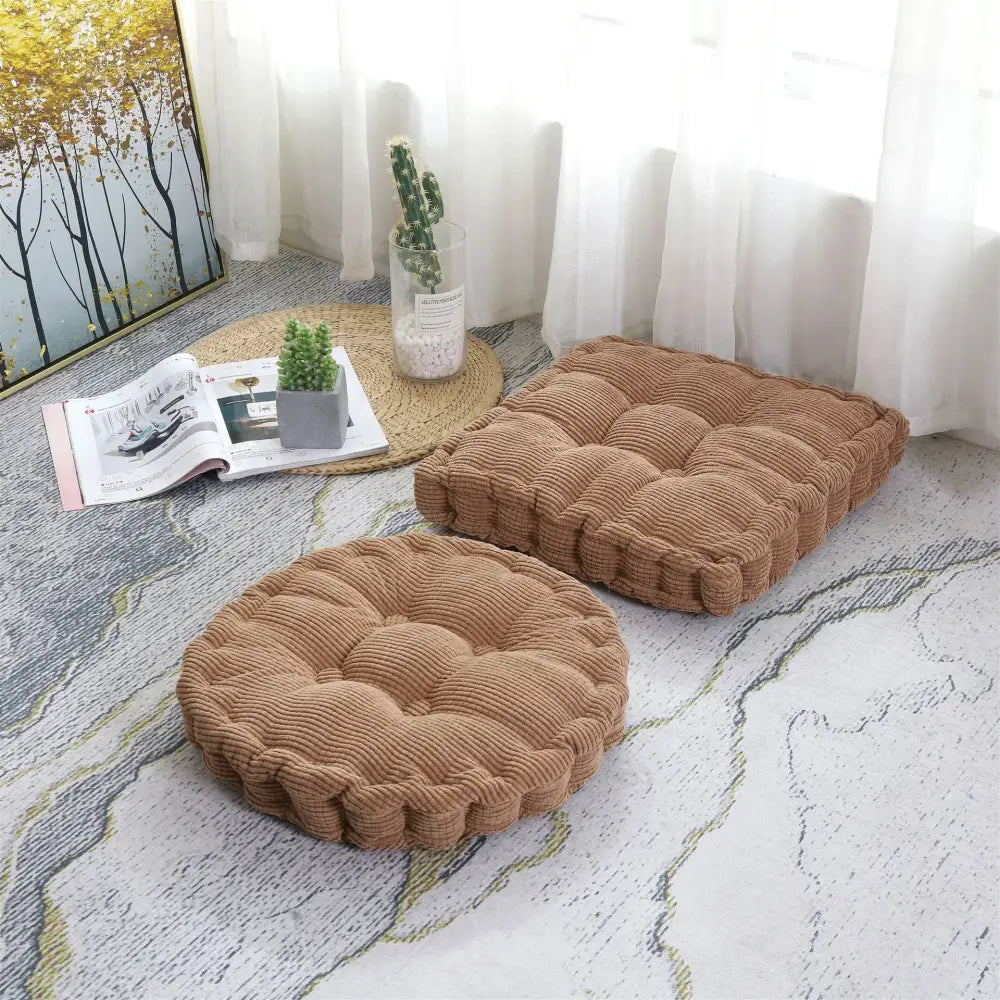 Two tan corduroy seat cushions with tufted floor design featuring round and square decorbites corduroy tufted pads