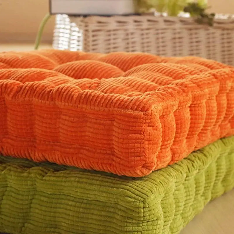 Vibrant orange corduroy tufted floor seat cushion resting atop a lime green decorbites corduroy tufted chair pad