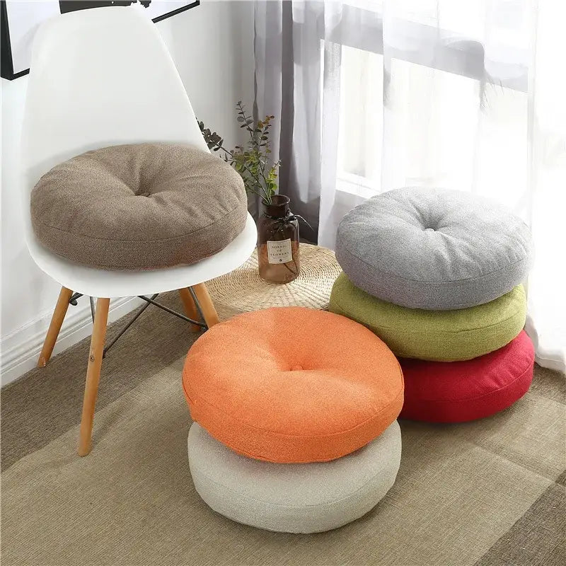 Round tufted grey linen floor pillow seating cushion with soft fabric in earthy tones for living room pouf use