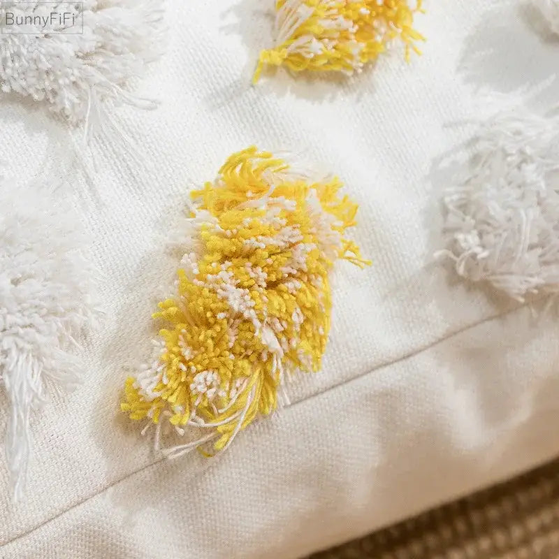 A soft off-white cushion cover with yellow and white tufted tassels pom-pom embellishment for decorbites boho style decor