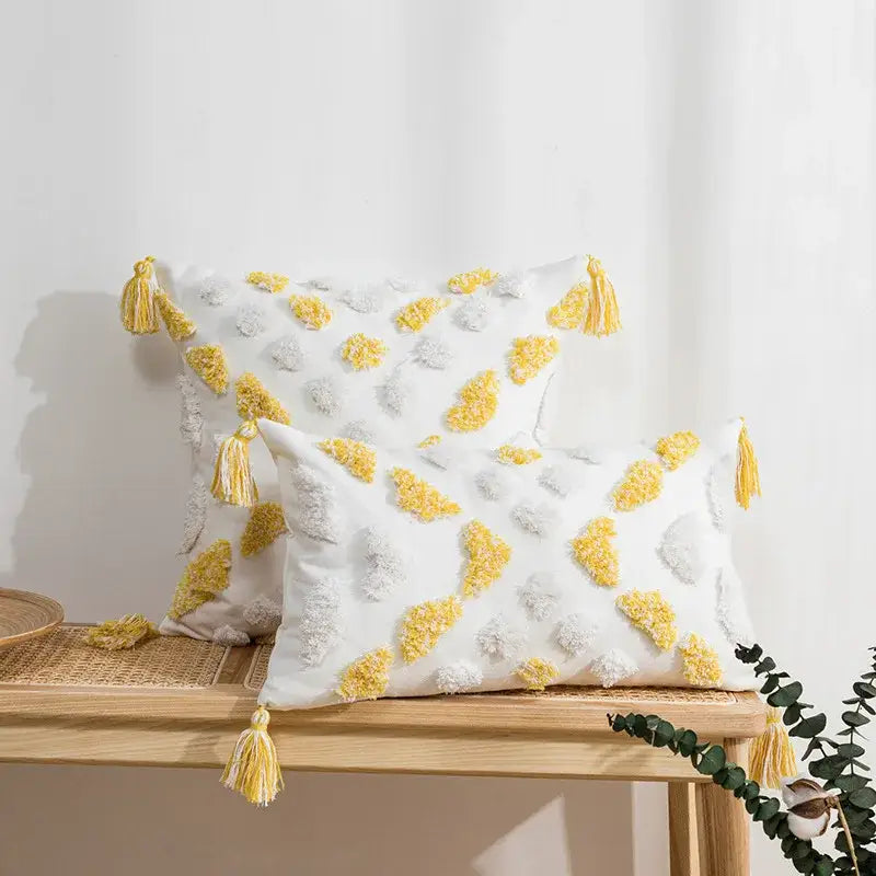 White cushion cover with yellow and gray tufted tassels for decorbites boho style living room decor