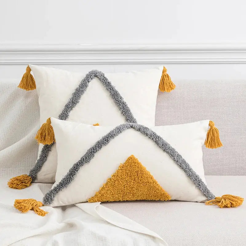 White cushion cover with tufted tassels in gray and mustard yellow decorbites boho style for living room decor