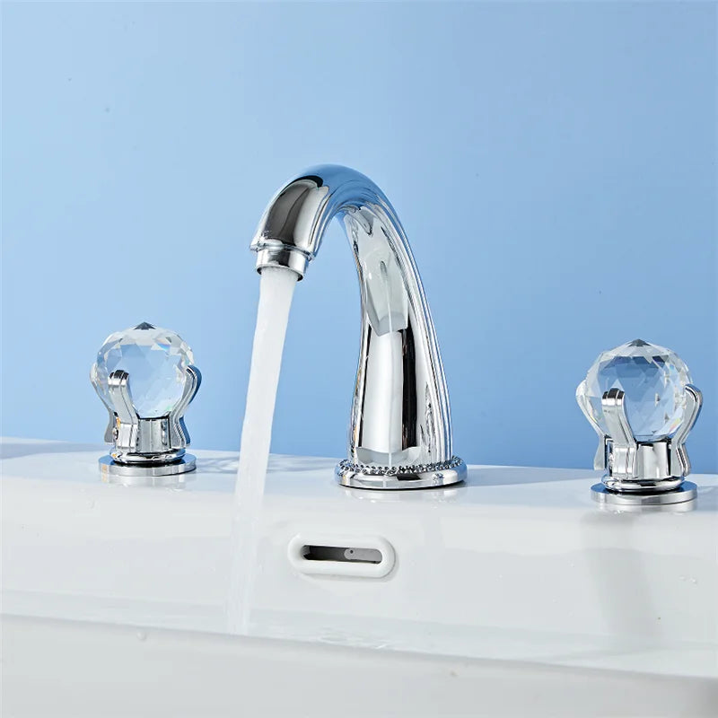 Chrome-finished Tuqiu Gold basin faucet with three crystal handles and cold water flowing from curved spout