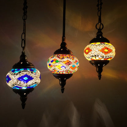 Mosaic glass pendant light with intricate geometric patterns and dark metal accents.