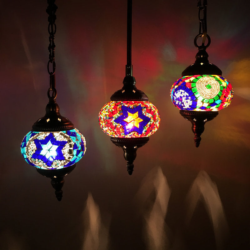 Mosaic glass pendant light with star and floral patterns, blue and red colors, black metal frame.