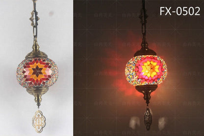 Mosaic glass pendant light with starburst pattern, multicolored design featuring reds and yellows on a metallic frame.