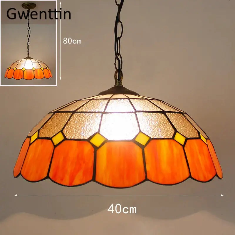 Orange and yellow stained glass pendant light with brass finish complementing turquoise and purple diamond square stained glass design