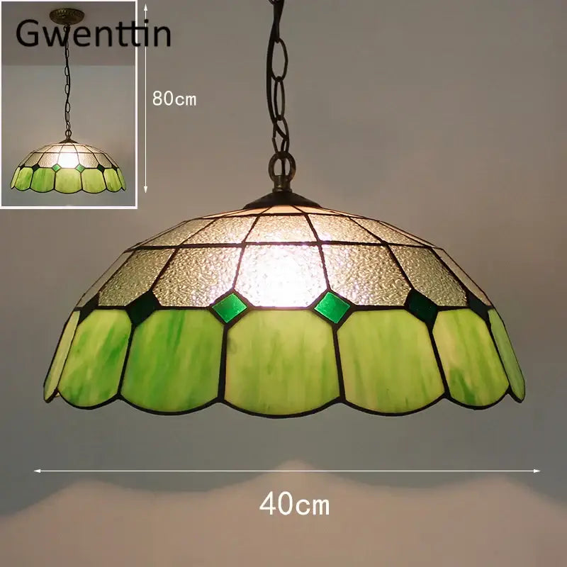 Green and gold stained glass pendant light with scalloped petals complements turquoise and purple diamond square stained glass