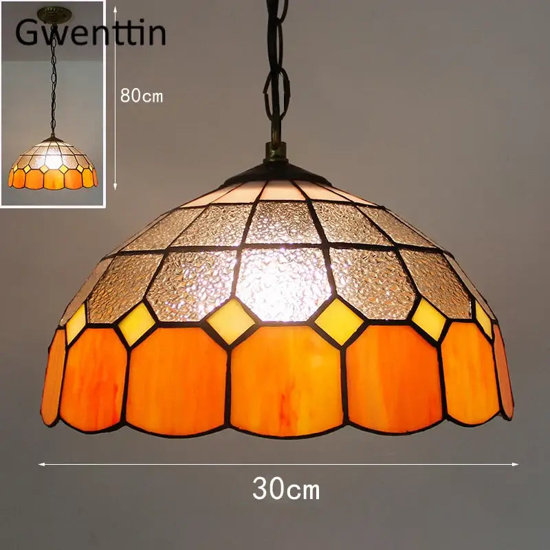 Pendant light with orange and amber hexagonal square stained glass and textured metallic accents for kitchen use